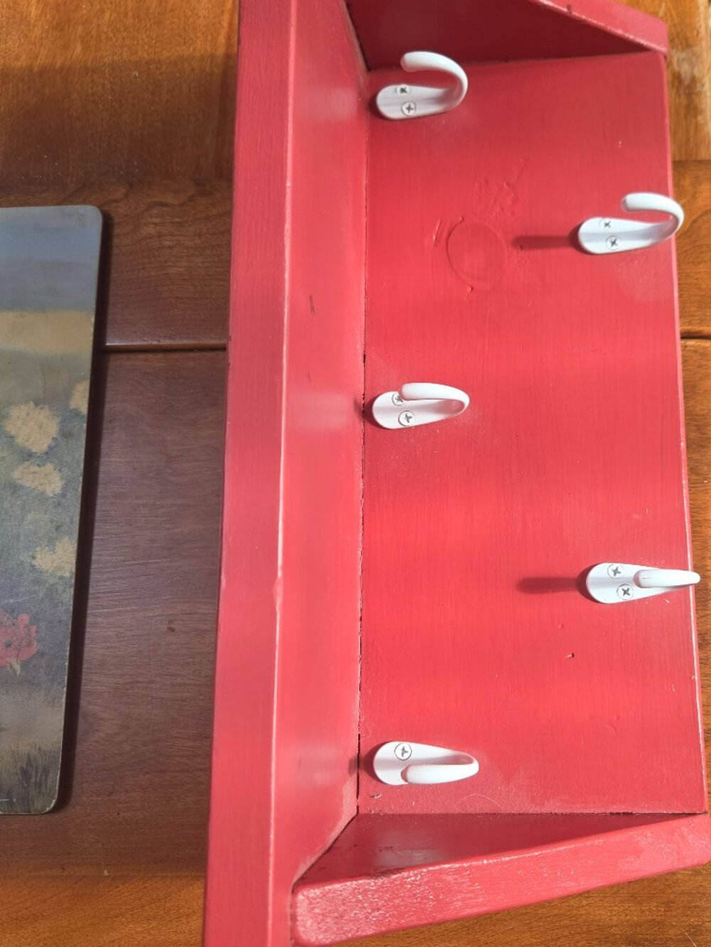 red wooden shelf with 5 hooks nice size has hooks on back to hang